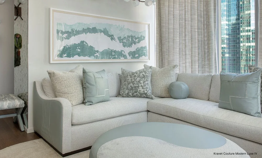 Pale upholstered seating and full-length drapery in a Kravet Couture interior