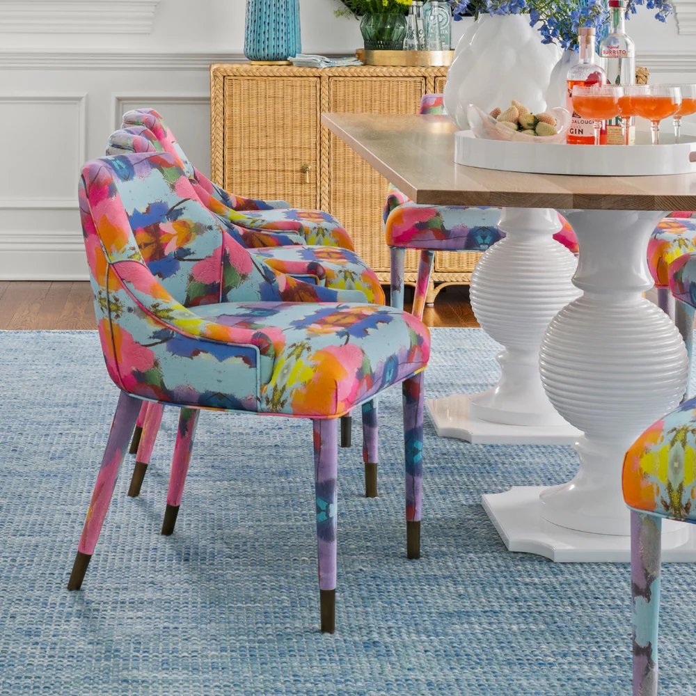 Colorful Laura Park patterned upholstery in a bright dining-room setting
